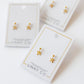 LINNY CO Millie Bow screwback stud earrings for kids & little girls — hypoallergenic, waterproof stainless steel with secure screwback backs, flat-lay styling.