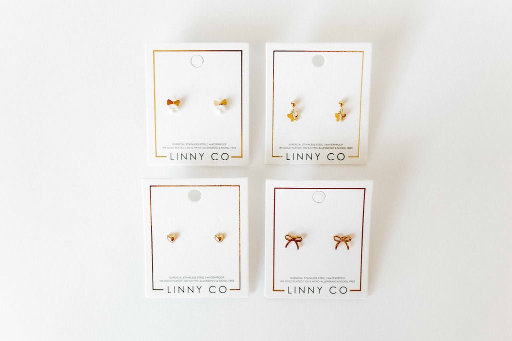 LINNY CO Millie Butterfly screwback stud earrings for kids & little girls — hypoallergenic, waterproof stainless steel with secure screwback backs, flat-lay styling.