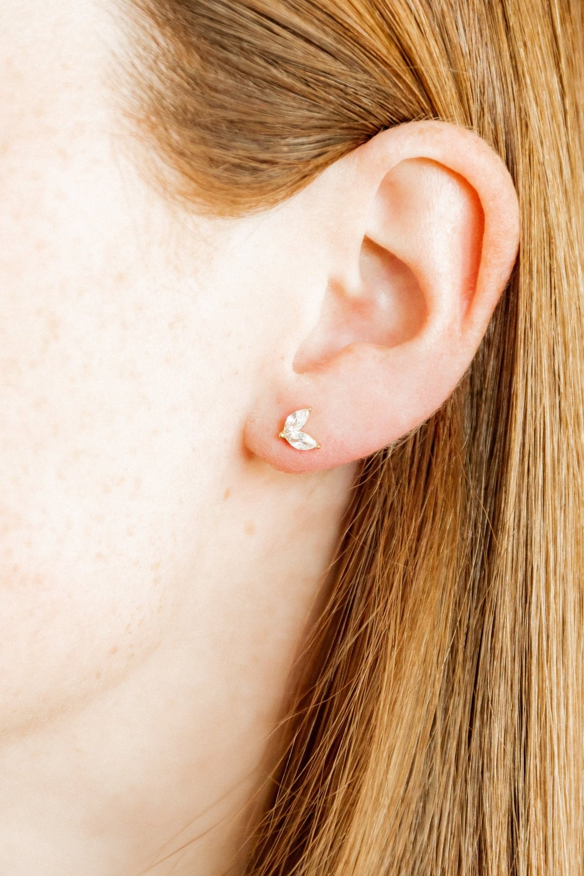 LINNY CO Nova Gold screwback stud earrings for kids & little girls — hypoallergenic, waterproof stainless steel with secure screwback backs, shown on model.