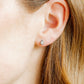 LINNY CO Paloma Pear Silver screwback stud earrings for kids & little girls — hypoallergenic, waterproof stainless steel with secure screwback backs, shown on model.