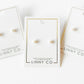 LINNY CO Payton Pearl White 5mm screwback stud earrings for kids & little girls — hypoallergenic, waterproof stainless steel with secure screwback backs, flat-lay styling.
