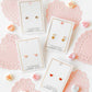 LINNY CO Polly Heart screwback stud earrings for kids & little girls — hypoallergenic, waterproof stainless steel with secure screwback backs, flat-lay styling.