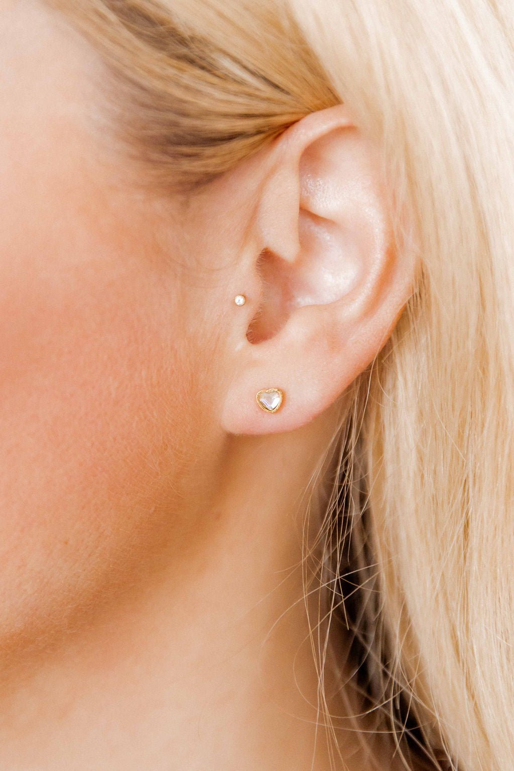 LINNY CO Polly Heart screwback stud earrings for kids & little girls — hypoallergenic, waterproof stainless steel with secure screwback backs, shown on model.