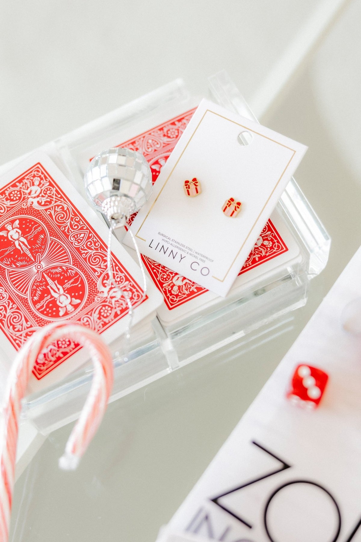 LINNY CO Present screwback stud earrings for kids & little girls — hypoallergenic, waterproof stainless steel with secure screwback backs, flat-lay styling.