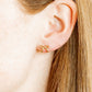 LINNY CO Sadie Bow Gold screwback stud earrings for kids & little girls — hypoallergenic, waterproof stainless steel with secure screwback backs, shown on model.