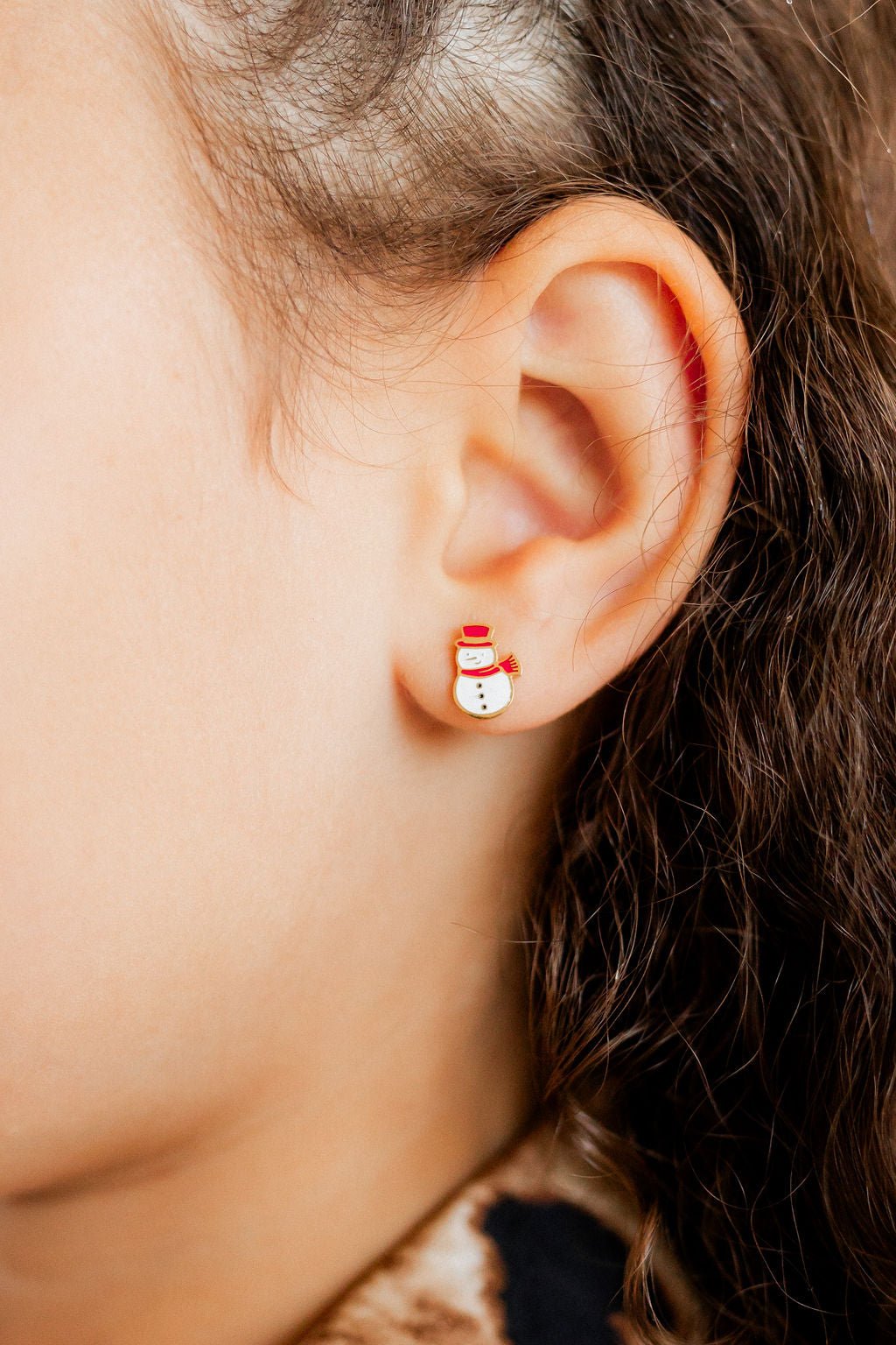 LINNY CO Snowman screwback stud earrings for kids & little girls — hypoallergenic, waterproof stainless steel with secure screwback backs, shown on model.