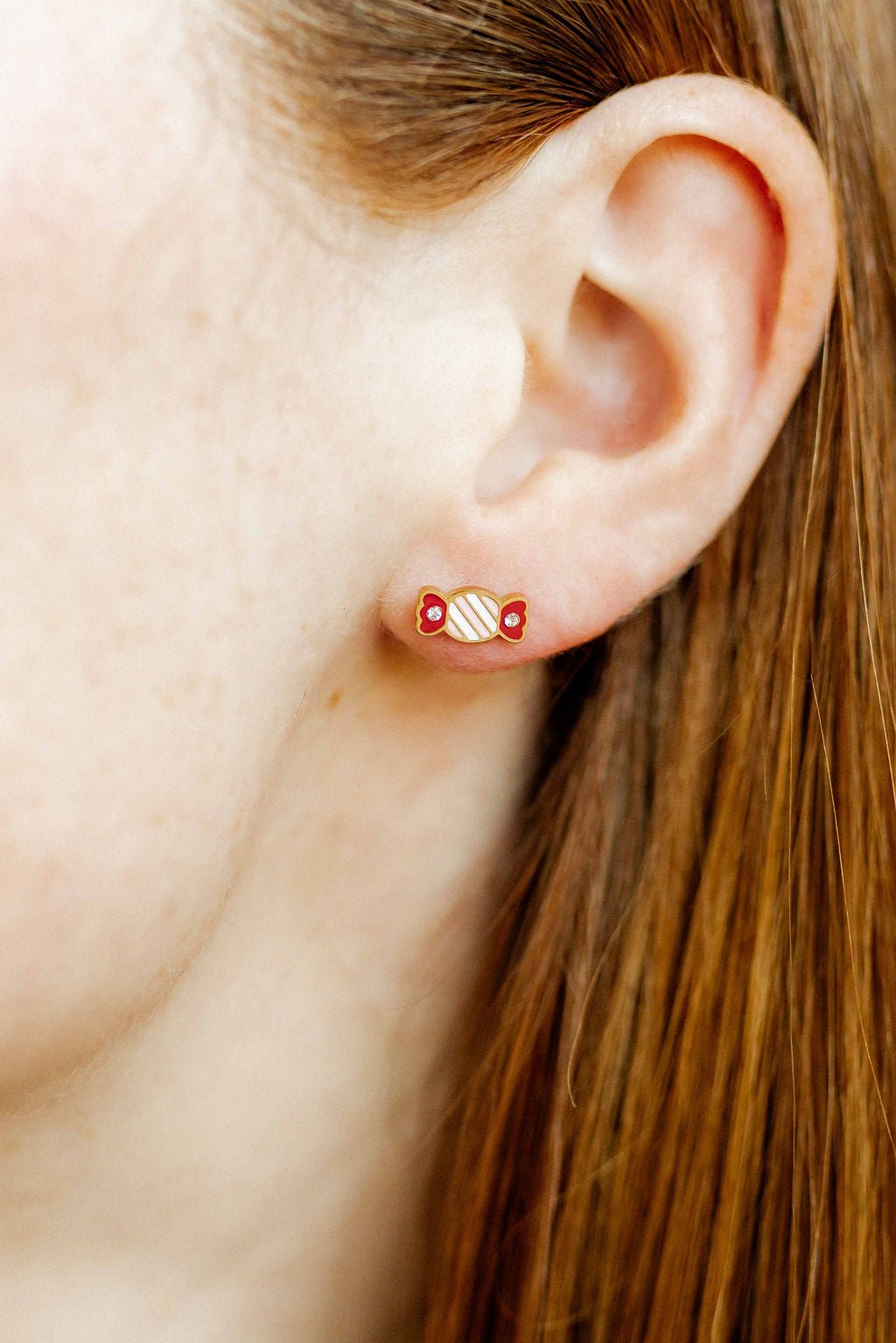LINNY CO Taffy screwback stud earrings for kids & little girls — hypoallergenic, waterproof stainless steel with secure screwback backs, shown on model.